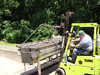 Our employees carefully loading Easy Black System onto wooden skids prior to shipment.