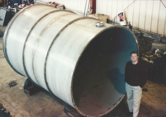 Patrick Smith, VP, inspecting large stainless steel waste water treatment tank prior to loading.
